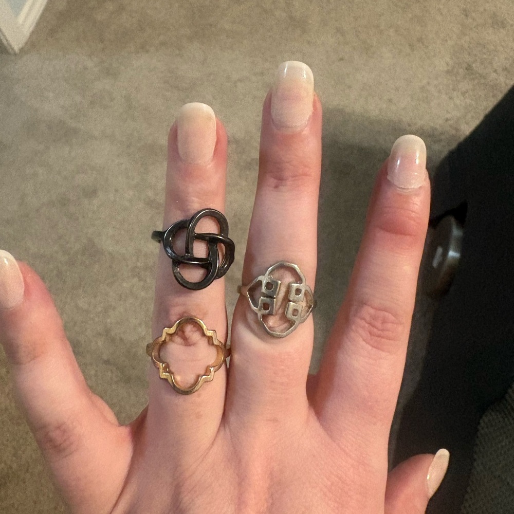 Elegant Trio of Black, Gold, and Silver Rings